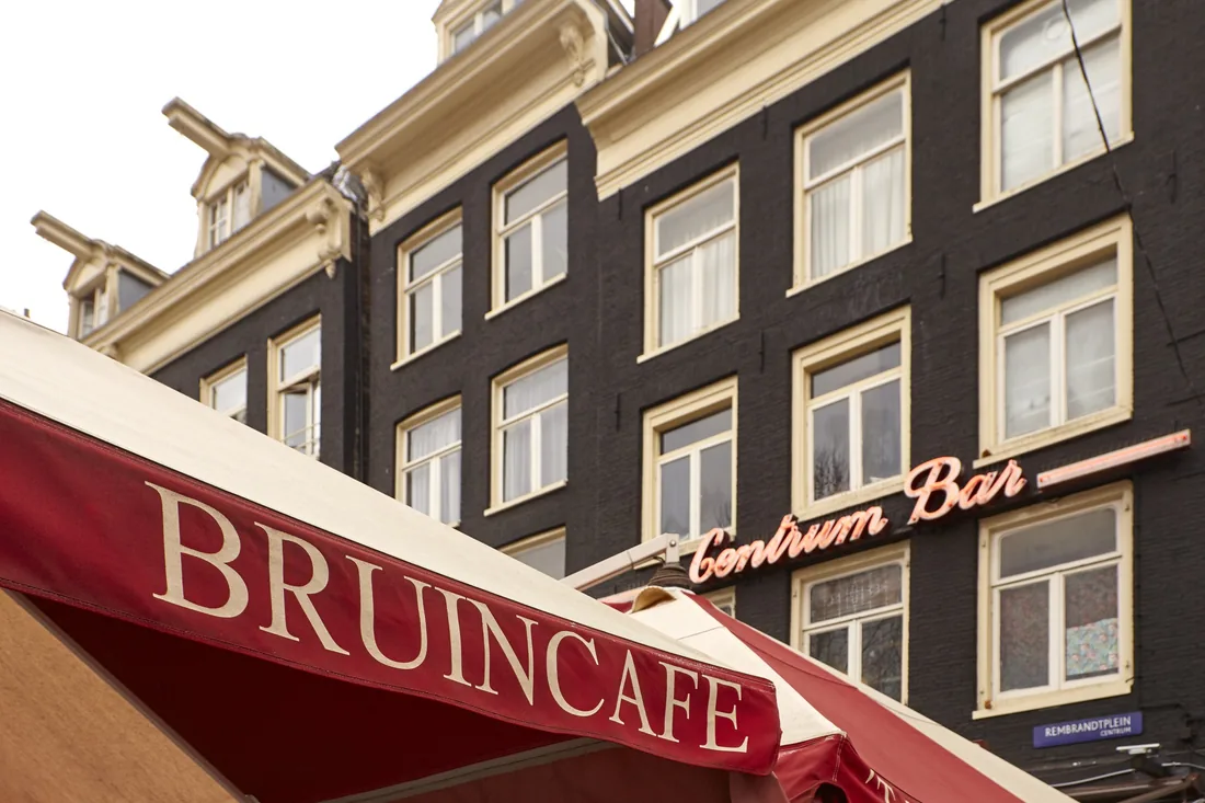 The façade with the neon Centrum Bar sign above the red awning